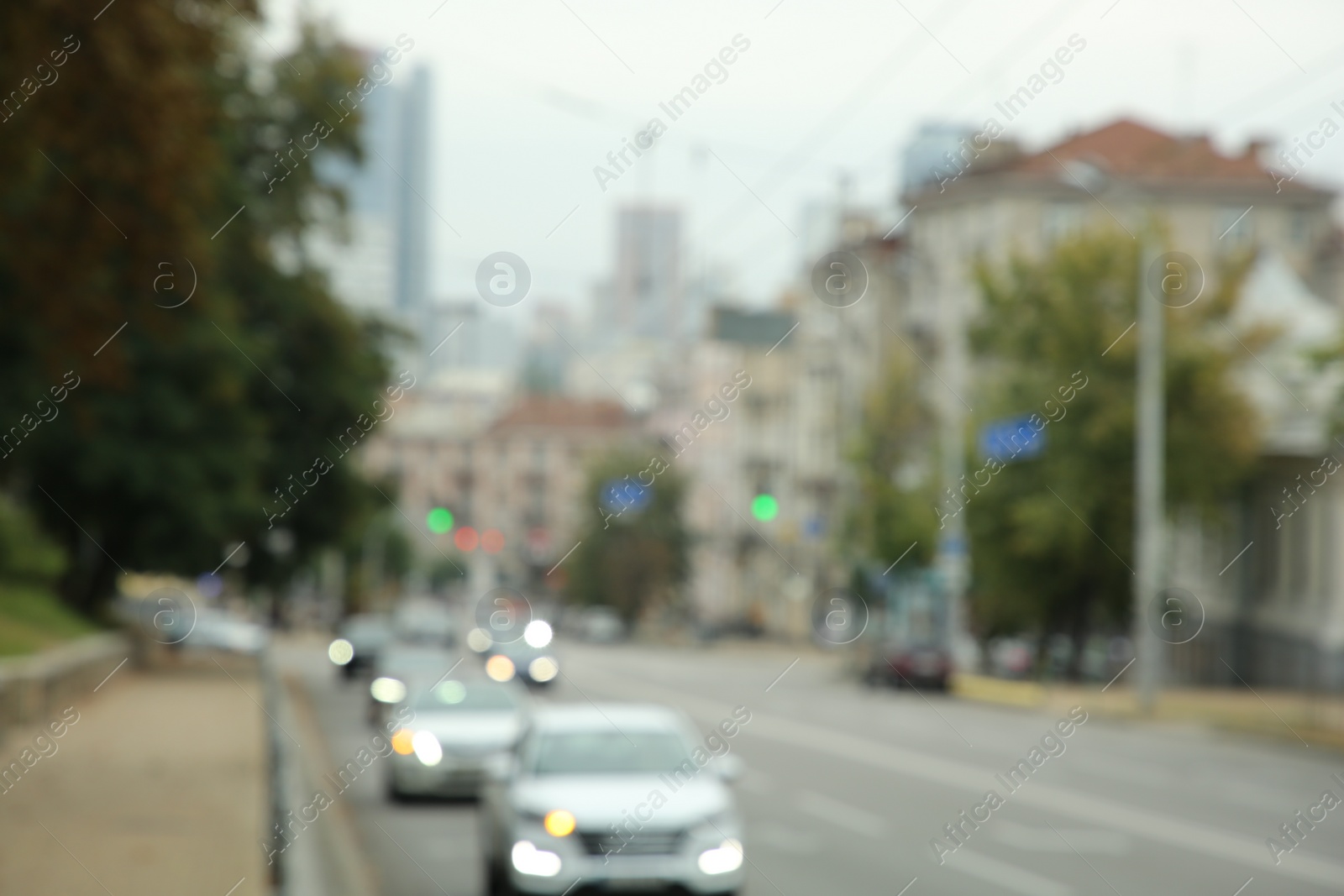 Photo of Blurred view of quiet street with beautiful buildings, road and trees