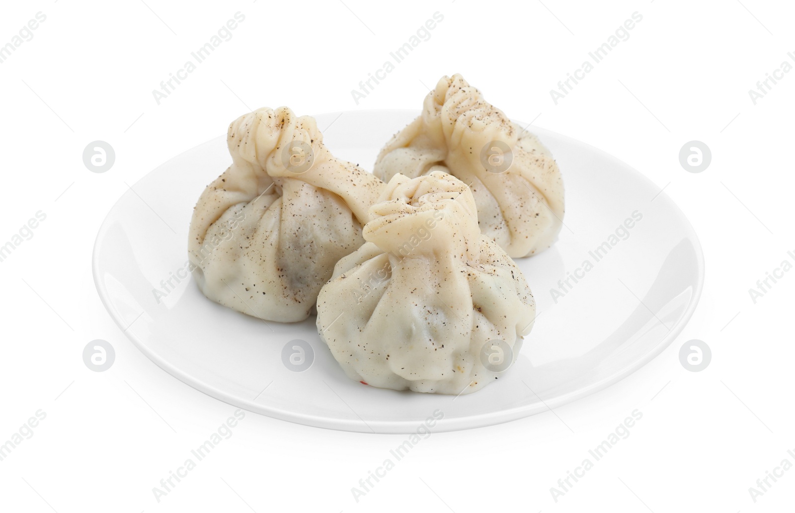 Photo of Plate with three tasty khinkali (dumplings) and spices isolated on white. Georgian cuisine