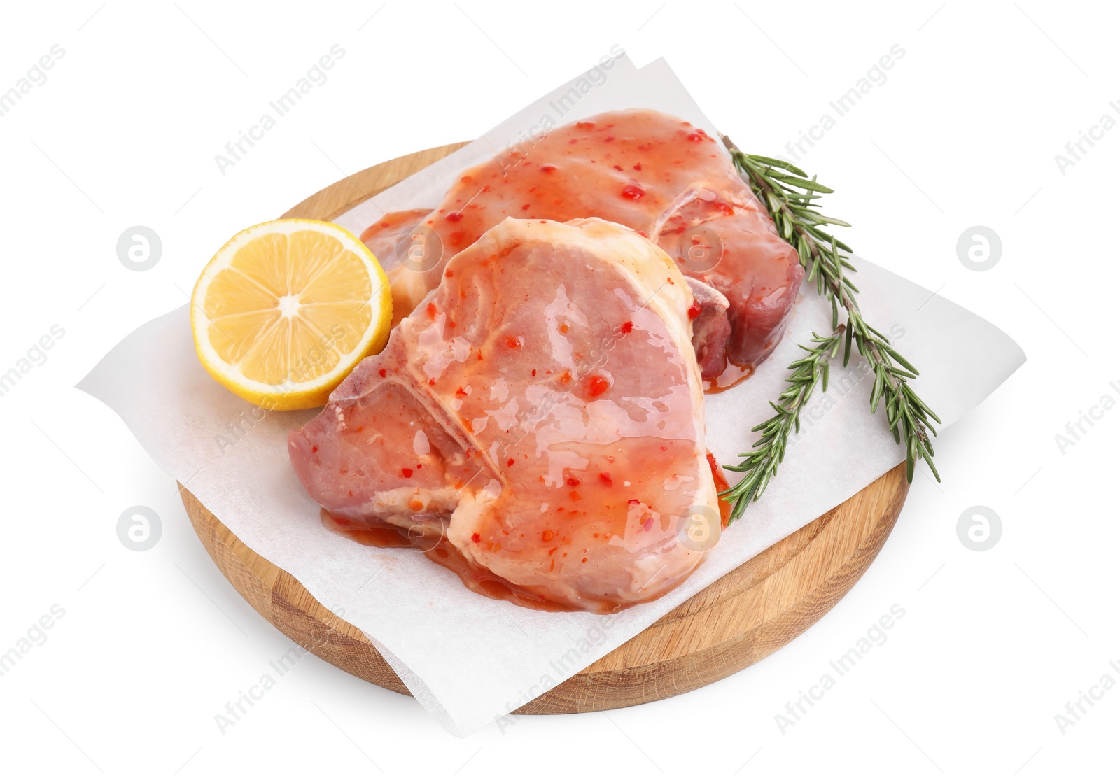 Photo of Board with raw marinated meat, lemon and rosemary isolated on white