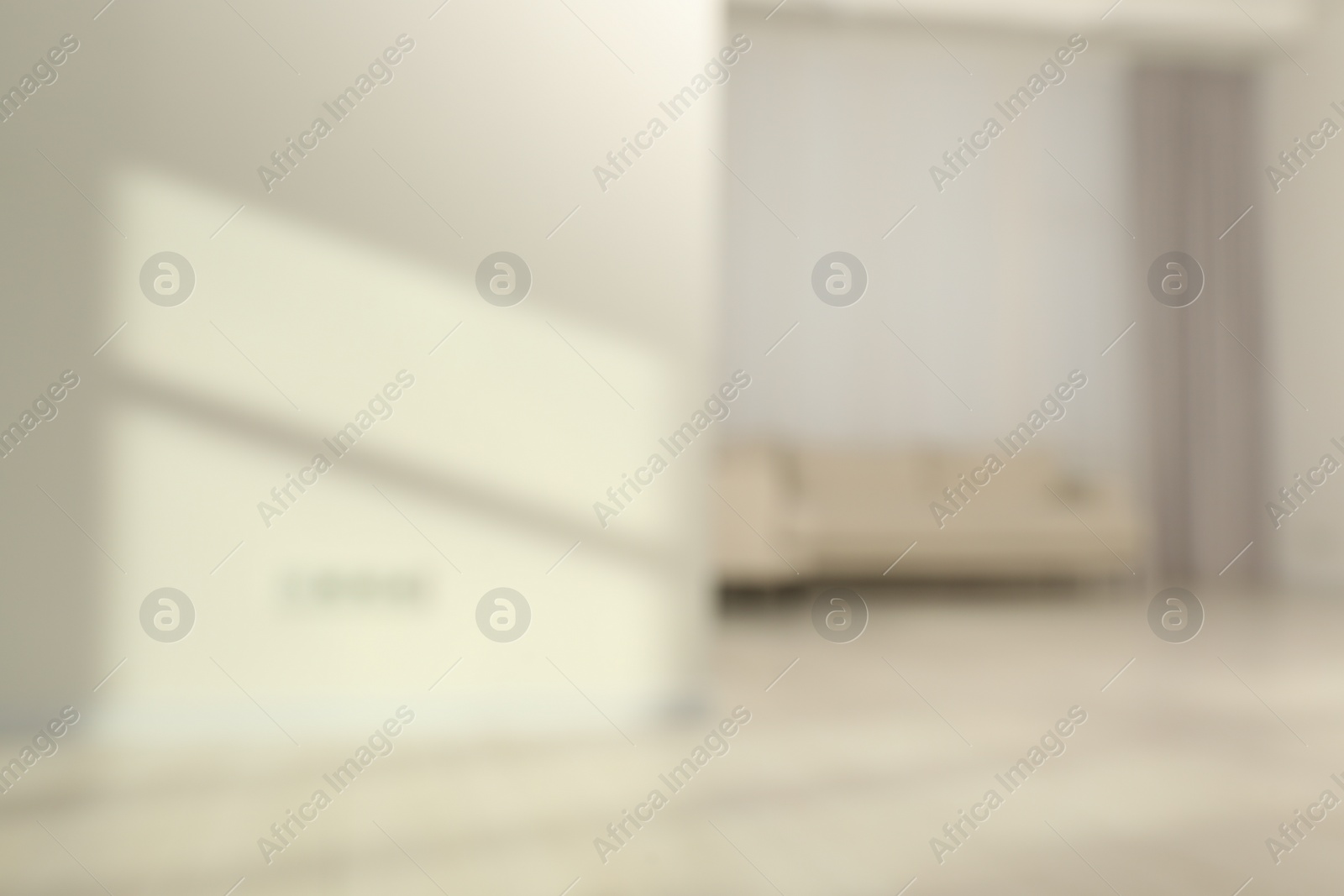 Photo of Blurred view of room with sofa and shadows on wall