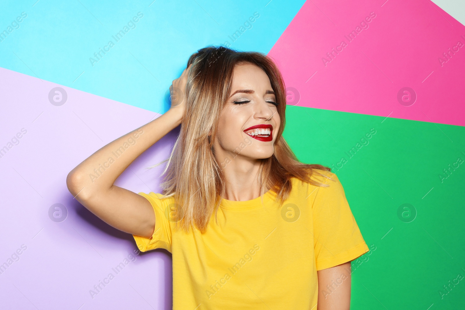 Photo of Beautiful young woman with healthy long blonde hair on color background