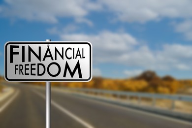 Image of Road sign with words Financial Freedom outdoors, space for text