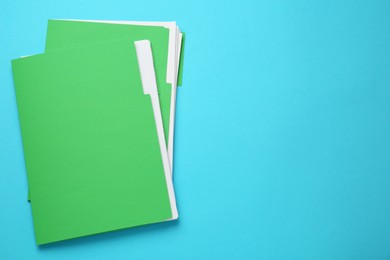 Light green files with documents on turquoise background, top view. Space for text