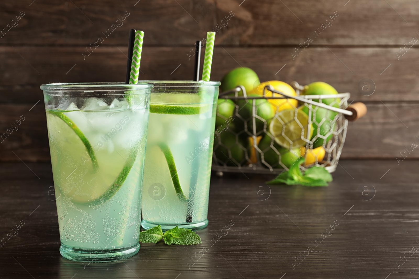 Photo of Natural lemonade with lime in glasses on table