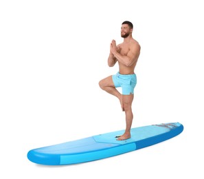 Photo of Happy man practicing yoga on blue SUP board against white background