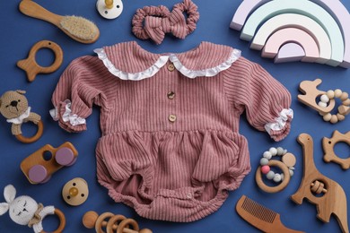 Photo of Flat lay composition with baby clothes and accessories on blue background