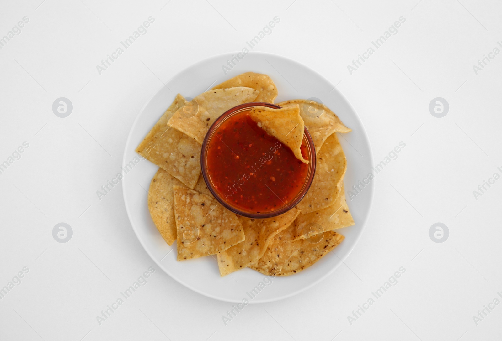 Photo of Tasty salsa sauce and tortilla chips on white background, top view