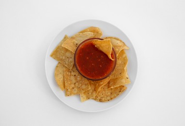 Photo of Tasty salsa sauce and tortilla chips on white background, top view