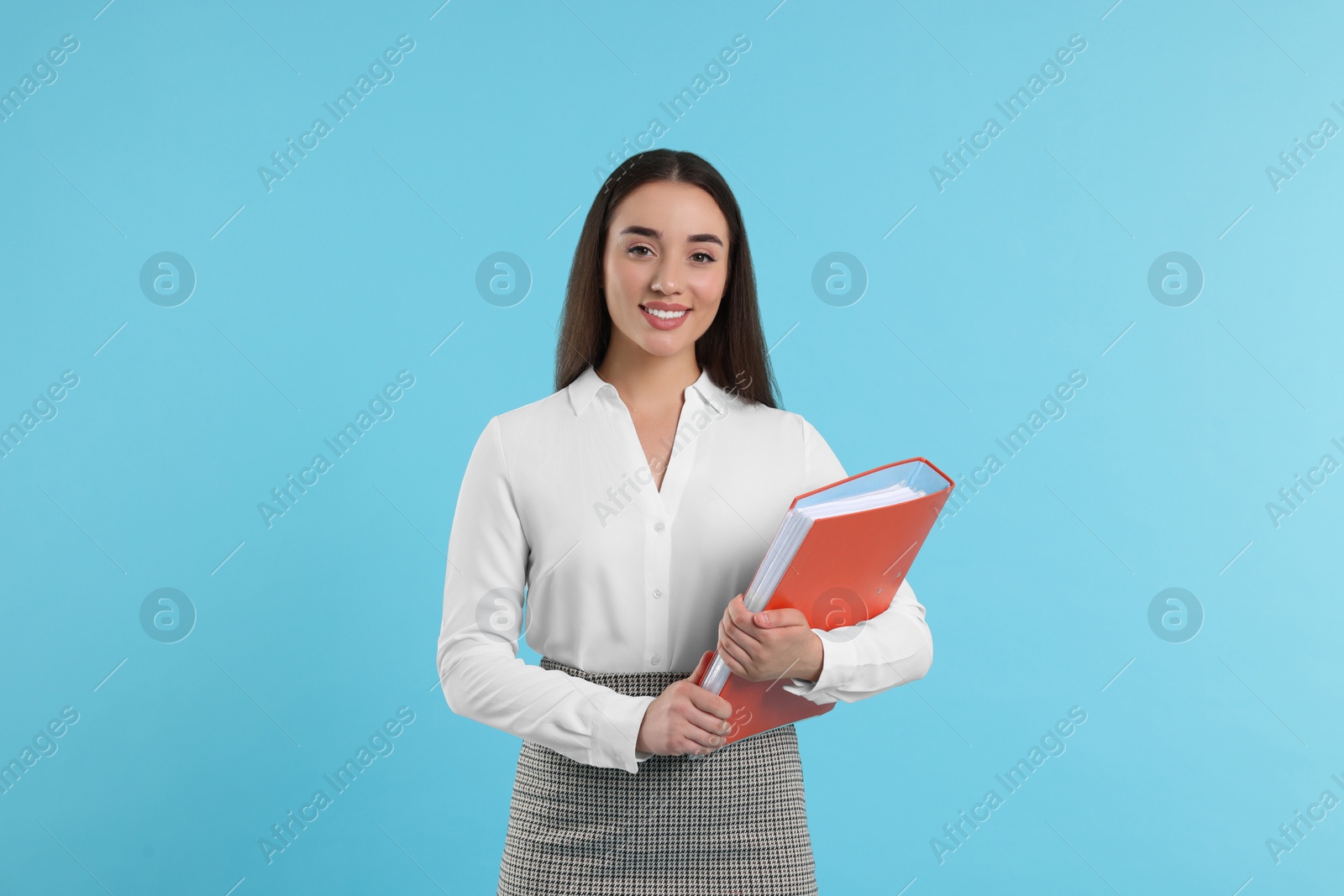 Photo of Happy woman with folder on light blue background