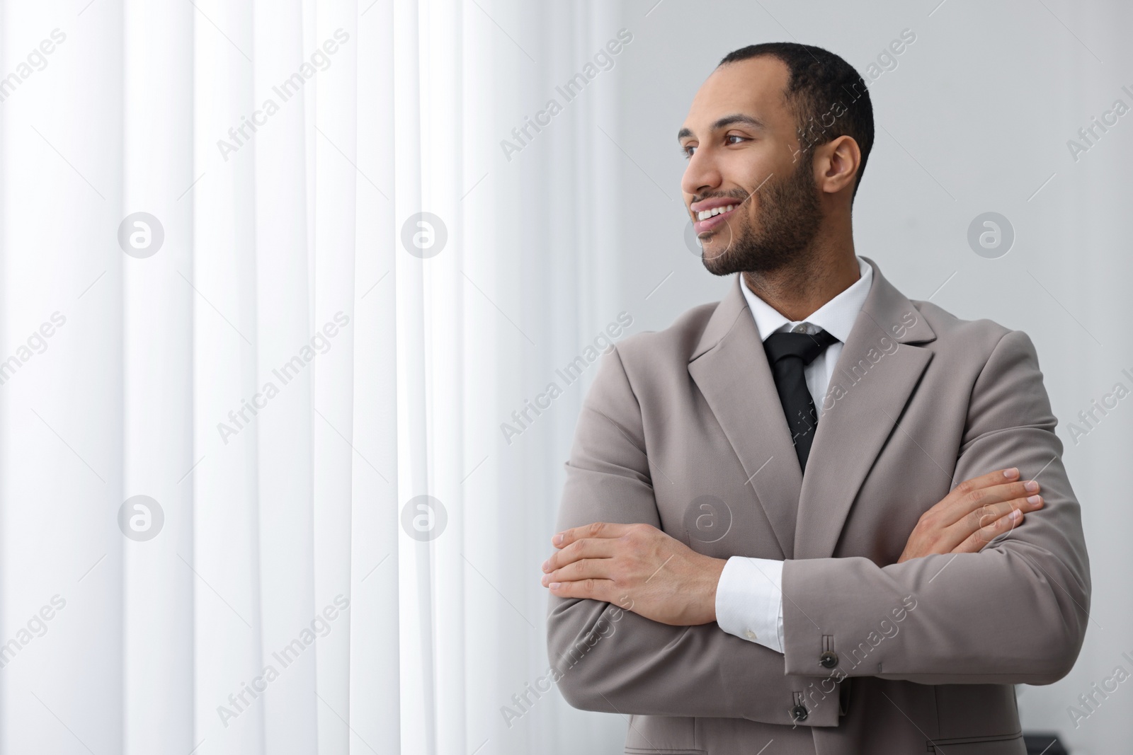 Photo of Portrait of smiling young man in office, space for text. Lawyer, businessman, accountant or manager