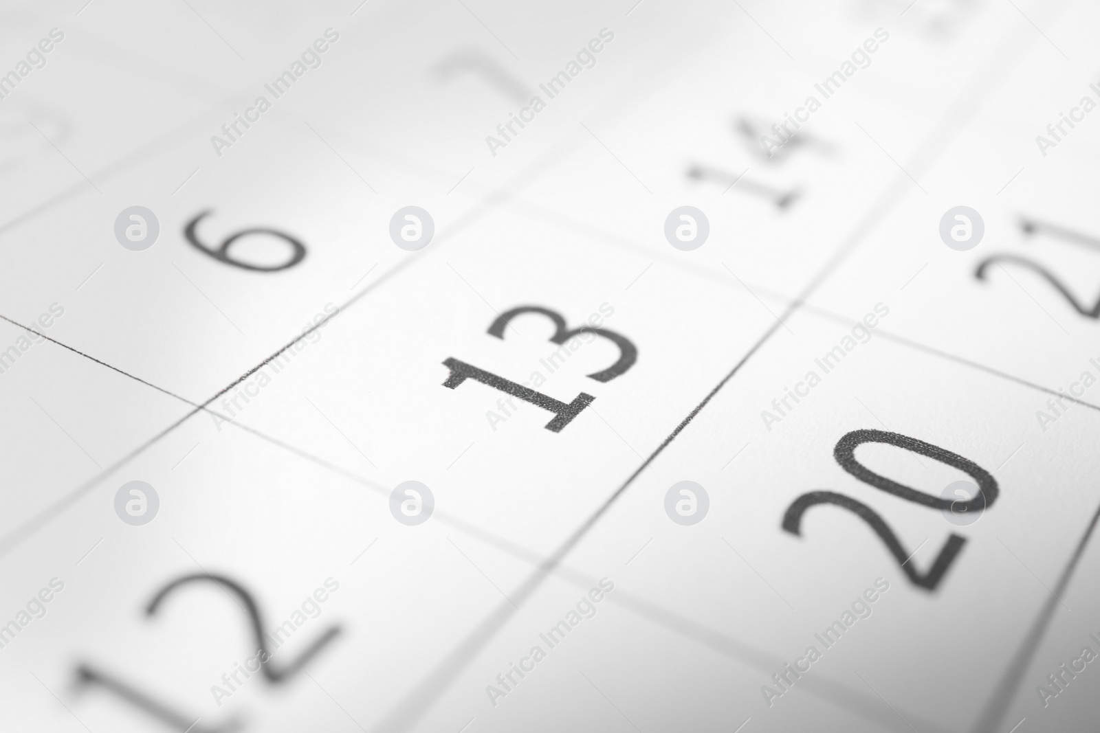 Photo of Closeup view of calendar page, focus on Friday 13. Bad luck superstition