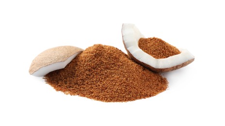 Ripe coconut and pile of brown sugar on white background