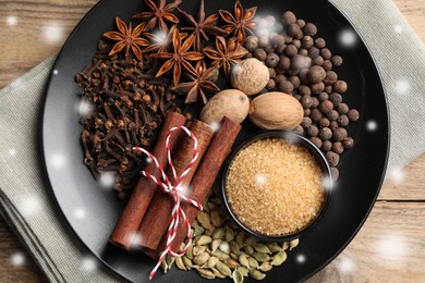 Different spices on wooden table, top view. Cinnamon, anise, cloves, allspice, nutmegs, brown sugar, cardamom