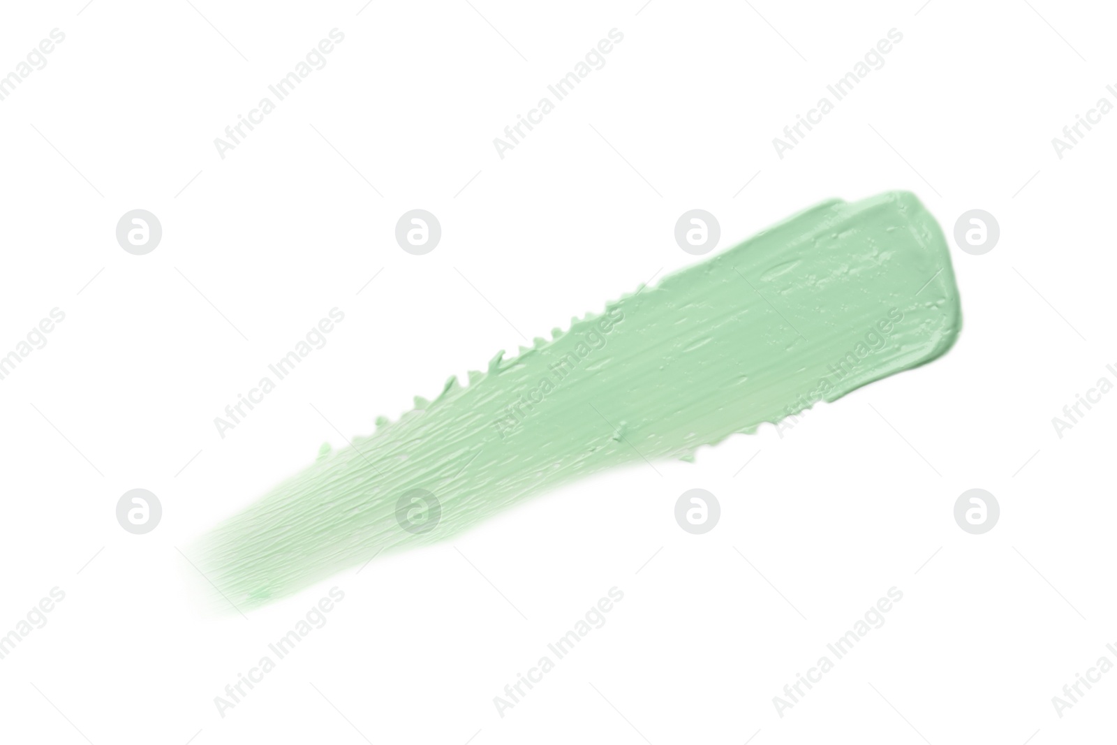 Photo of Stroke of green color correcting concealer isolated on white, top view