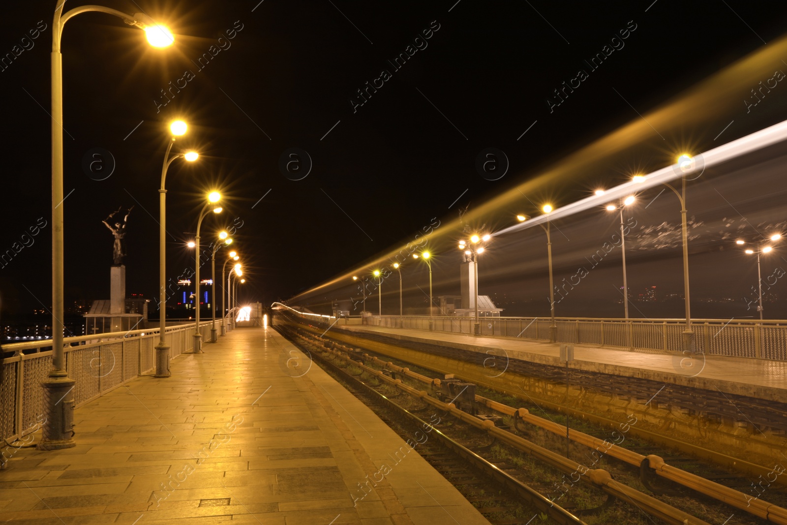 Photo of Night metro railroad with illumination in modern city