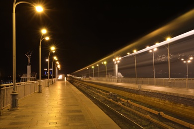 Night metro railroad with illumination in modern city