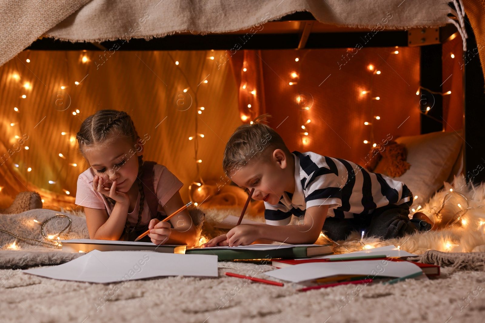 Photo of Children drawing in play tent at home