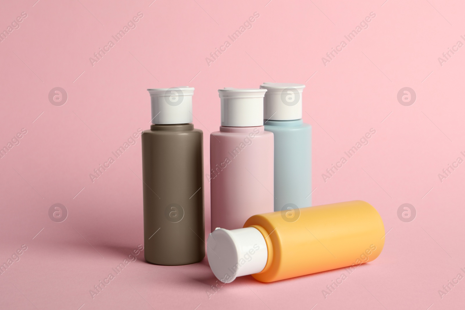 Photo of Cosmetic travel on pink background. Bath accessories