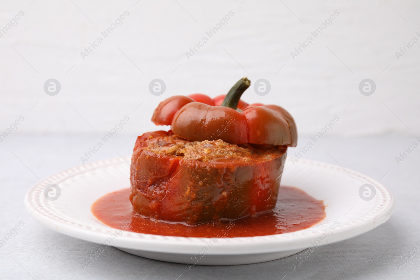 Photo of Delicious stuffed bell pepper on light table