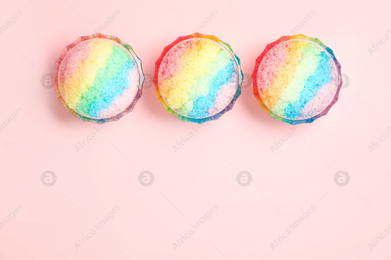 Photo of Rainbow shaving ice in glass dessert bowls on light background, flat lay. Space for text