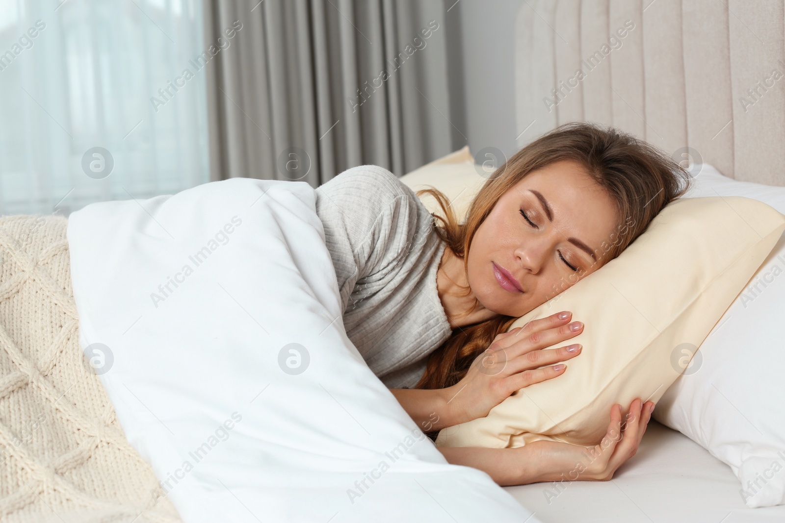 Photo of Beautiful woman sleeping in bed at home