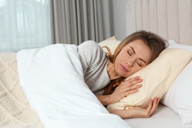 Beautiful woman sleeping in bed at home