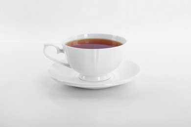 Tasty tea in cup on white background