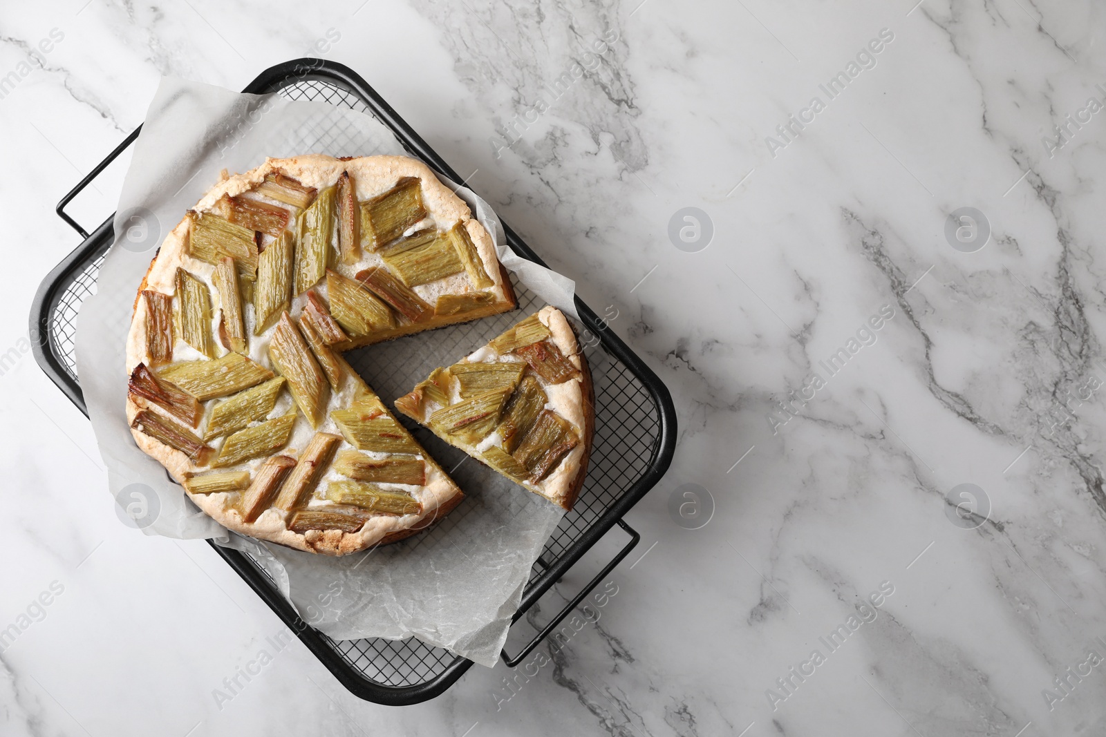 Photo of Freshly baked rhubarb pie on white marble table, top view. Space for text