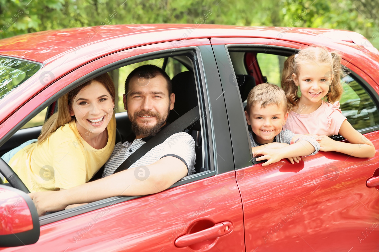 Photo of Happy family with children taking road trip together