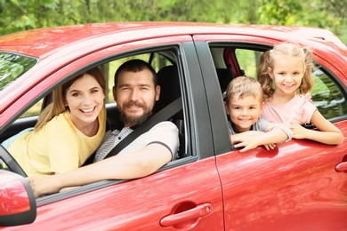 Photo of Happy family with children taking road trip together