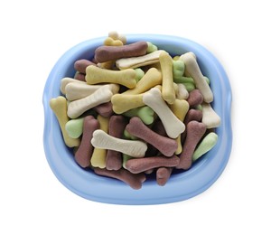 Photo of Different bone shaped dog cookies in feeding bowl isolated on white, top view