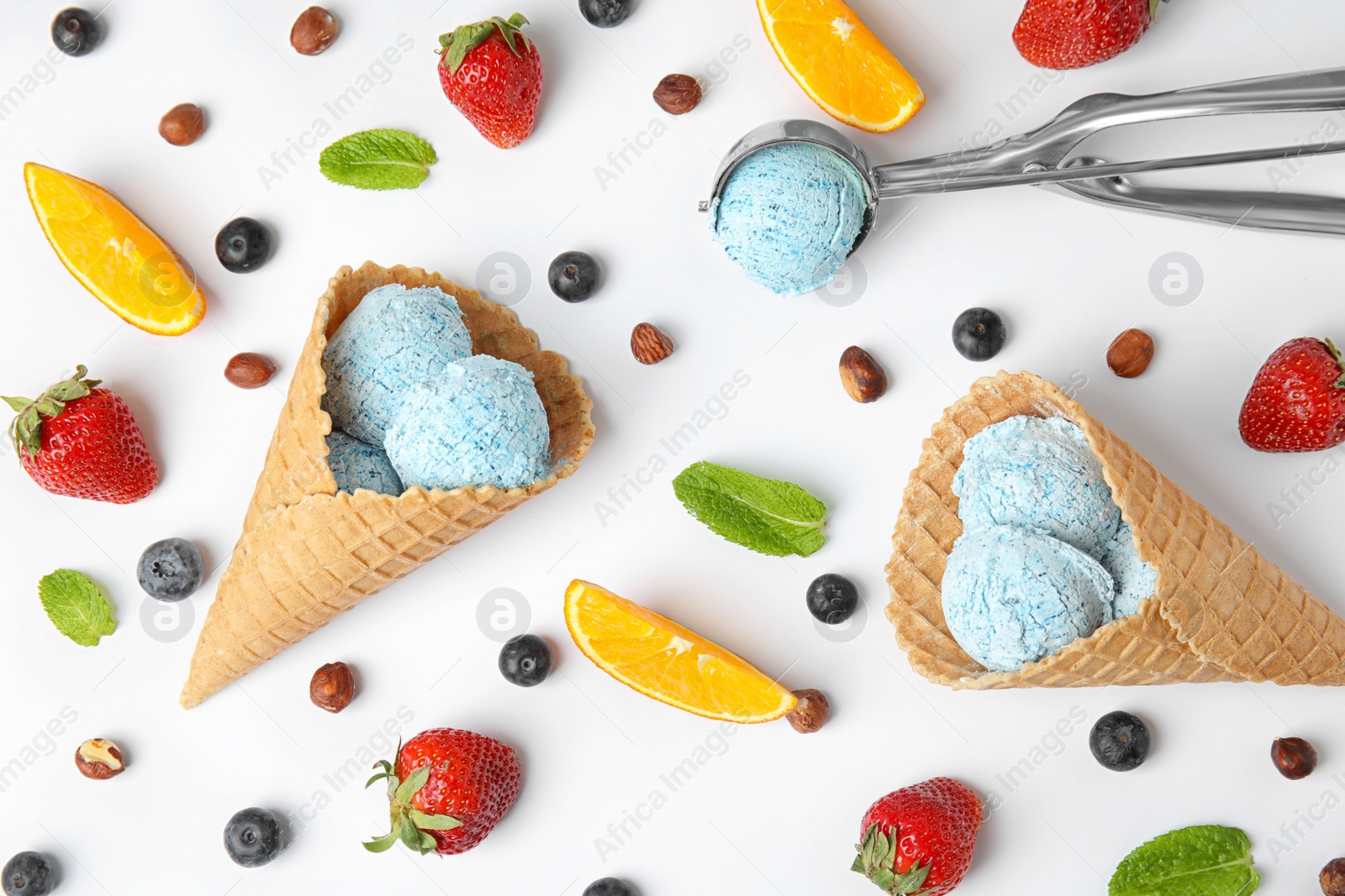 Photo of Composition with delicious ice creams in waffle cones on white background, top view