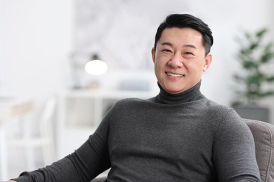 Portrait of smiling businessman on blurred background. Space for text