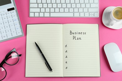 Flat lay composition of notebook with words Business Plan on pink background