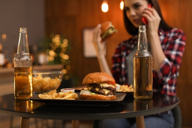 Photo of Tasty burger and french fries served on table in cafe