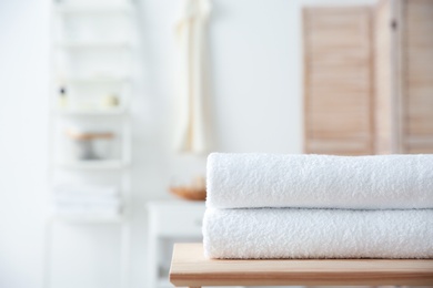 Stack of towels on table against blurred background