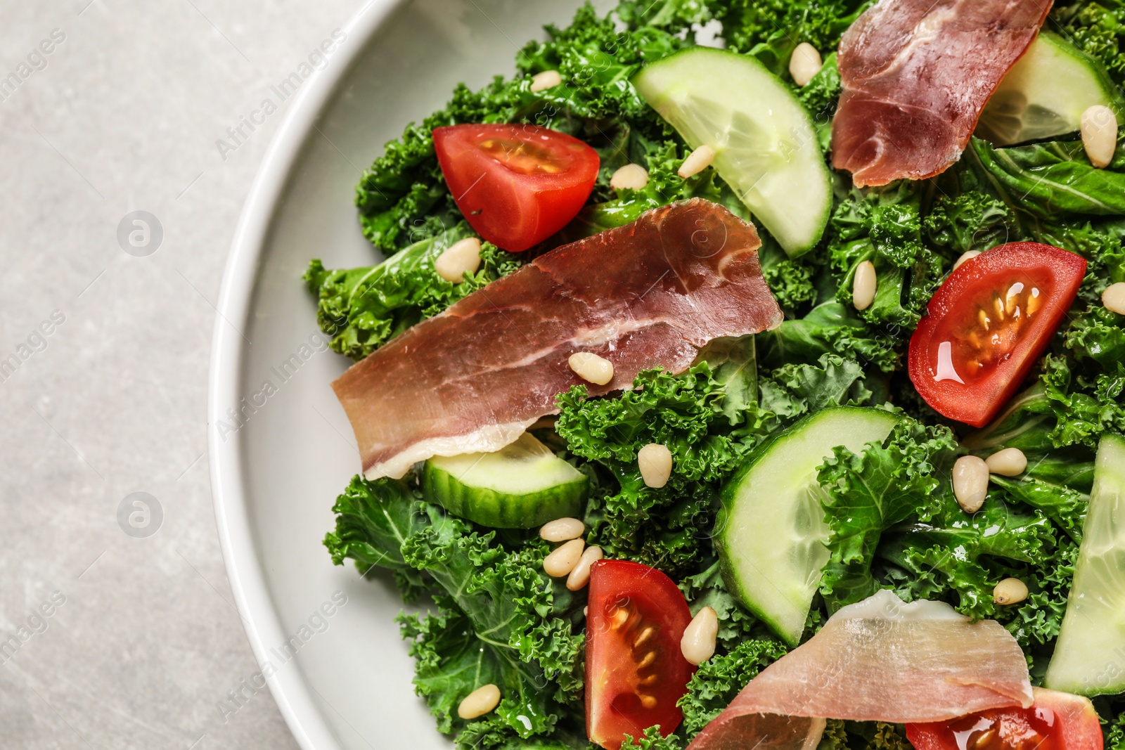 Photo of Delicious kale salad on grey table, top view