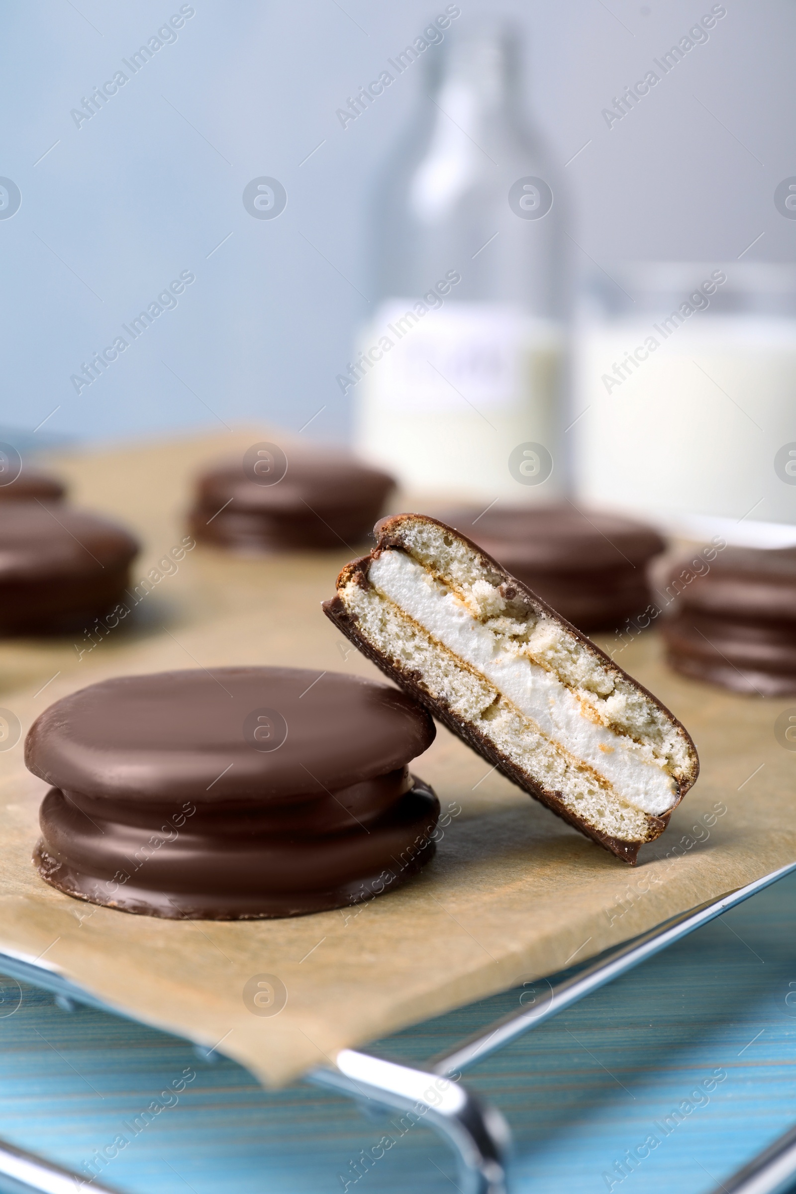 Photo of Tasty choco pies on parchment paper, closeup view