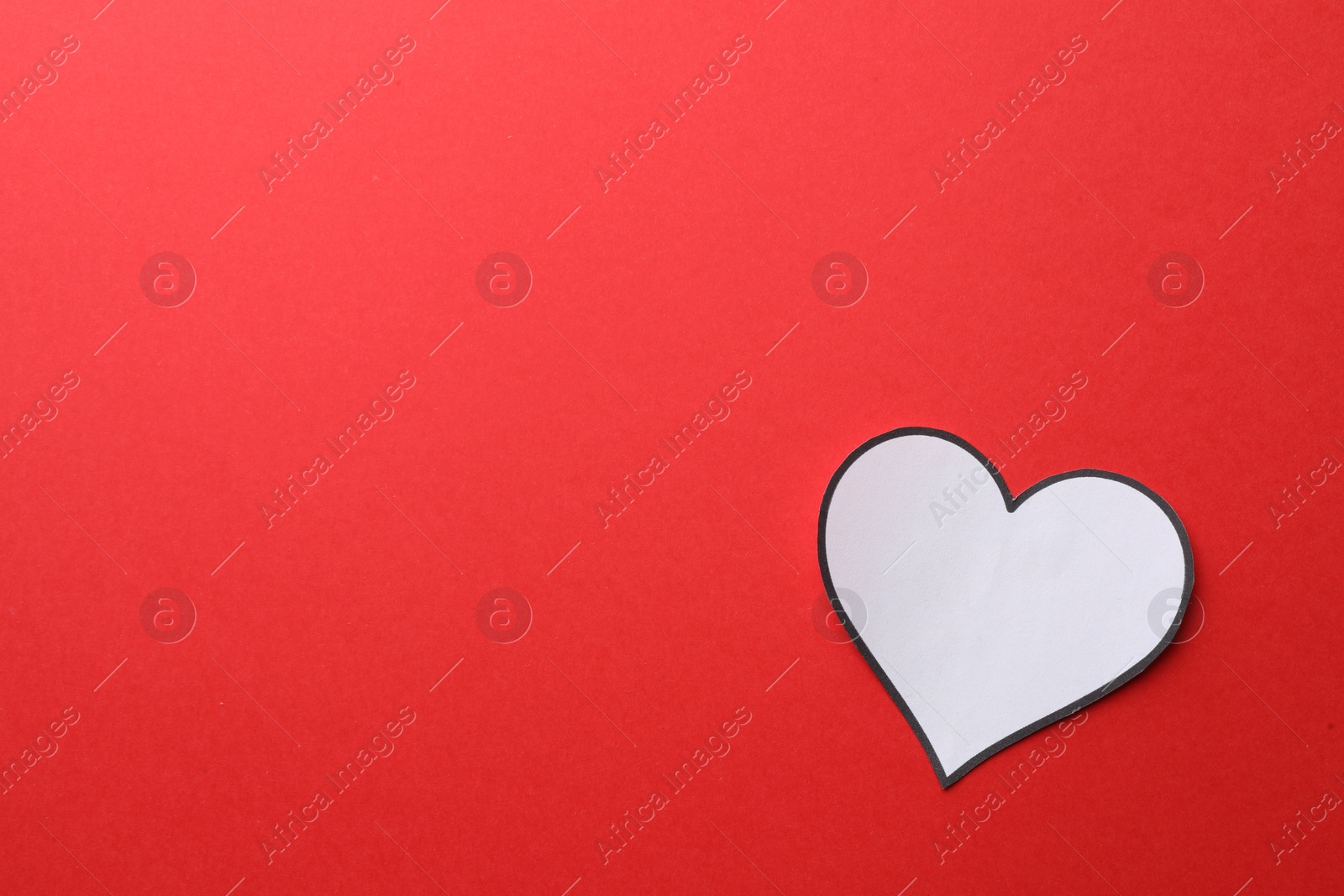 Photo of White paper heart on red background, top view. Space for text