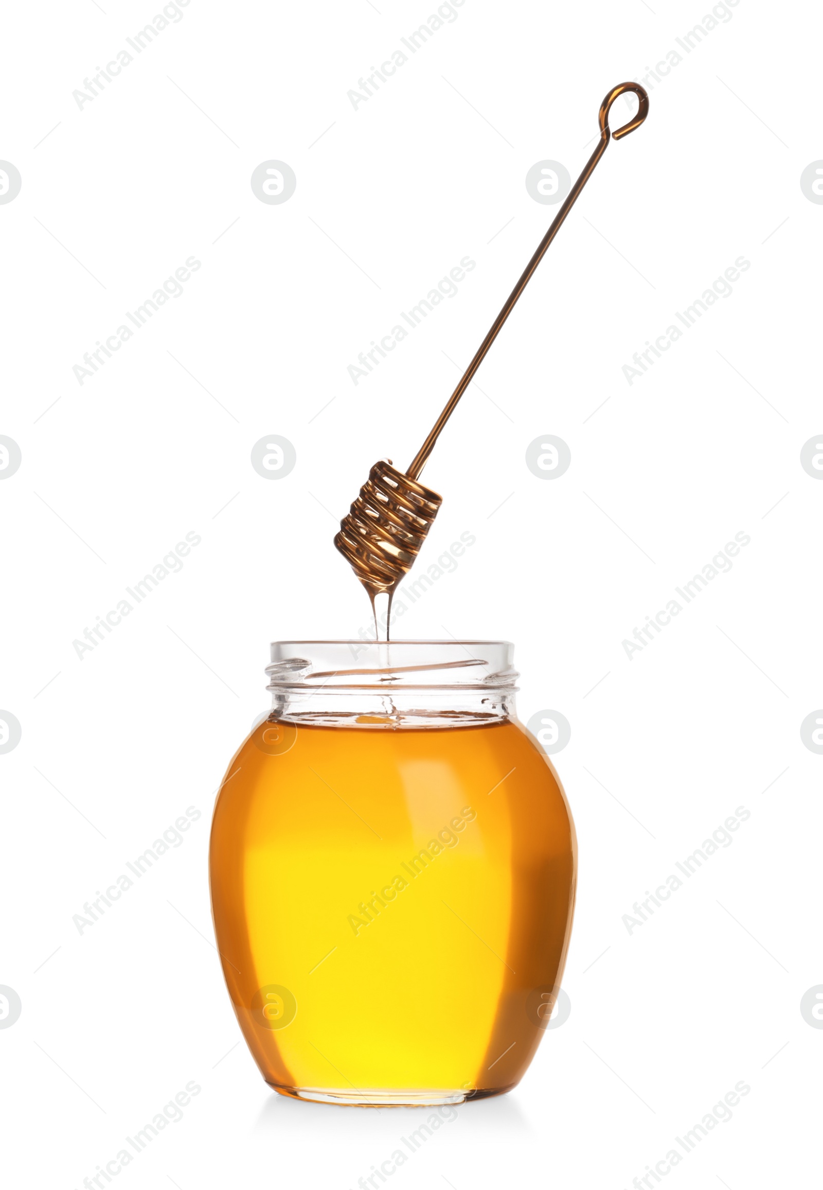 Photo of Honey dripping from dipper into jar isolated on white