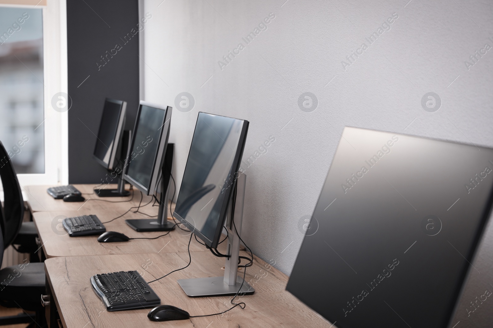 Photo of Many modern computers in open space office