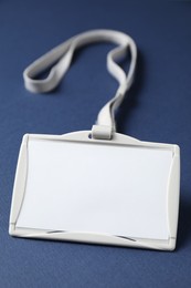 Photo of Blank badge with string on blue background