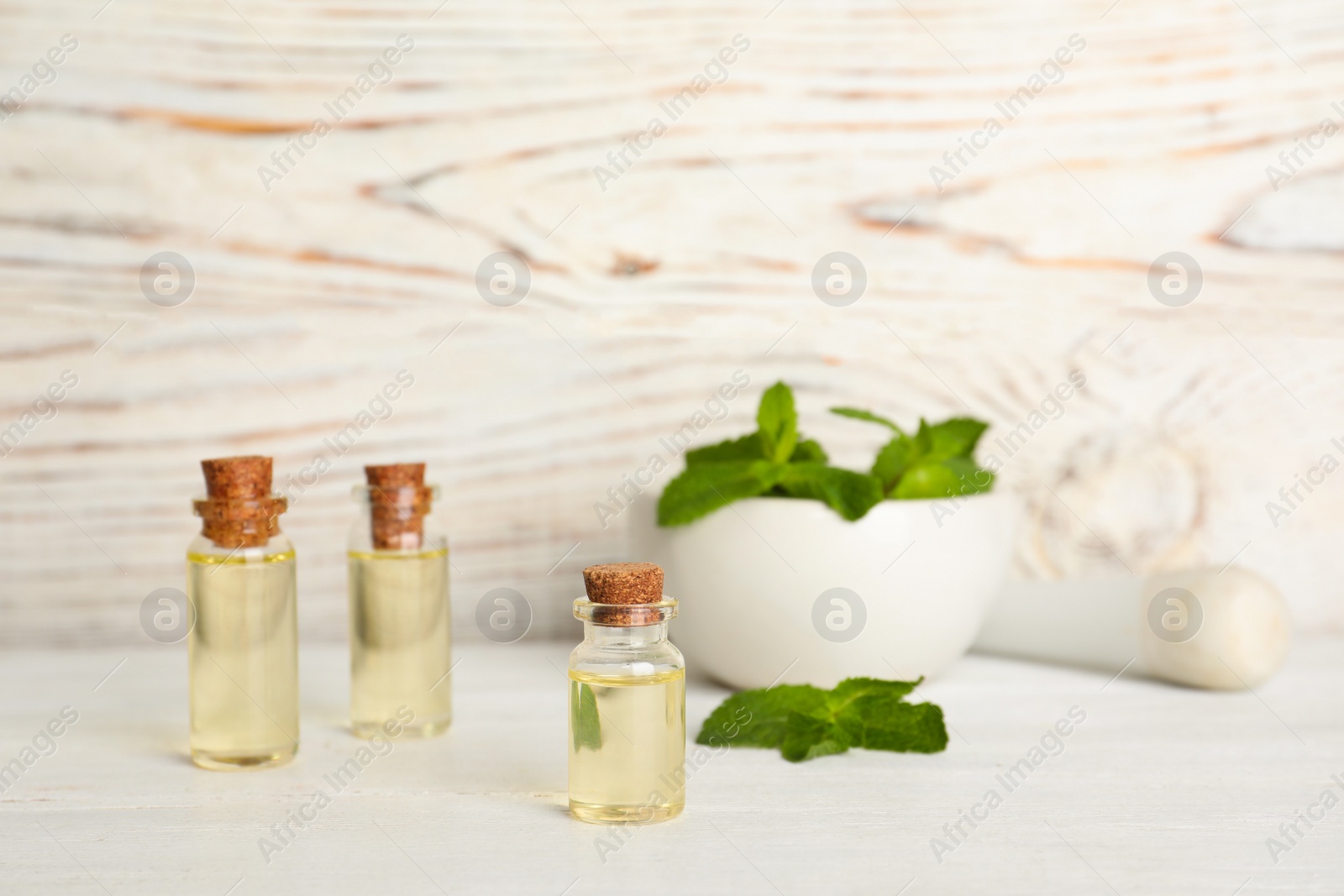 Photo of Composition with essential oil in glass bottles on table