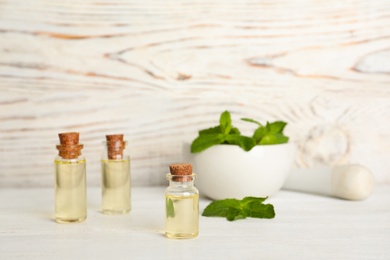 Composition with essential oil in glass bottles on table