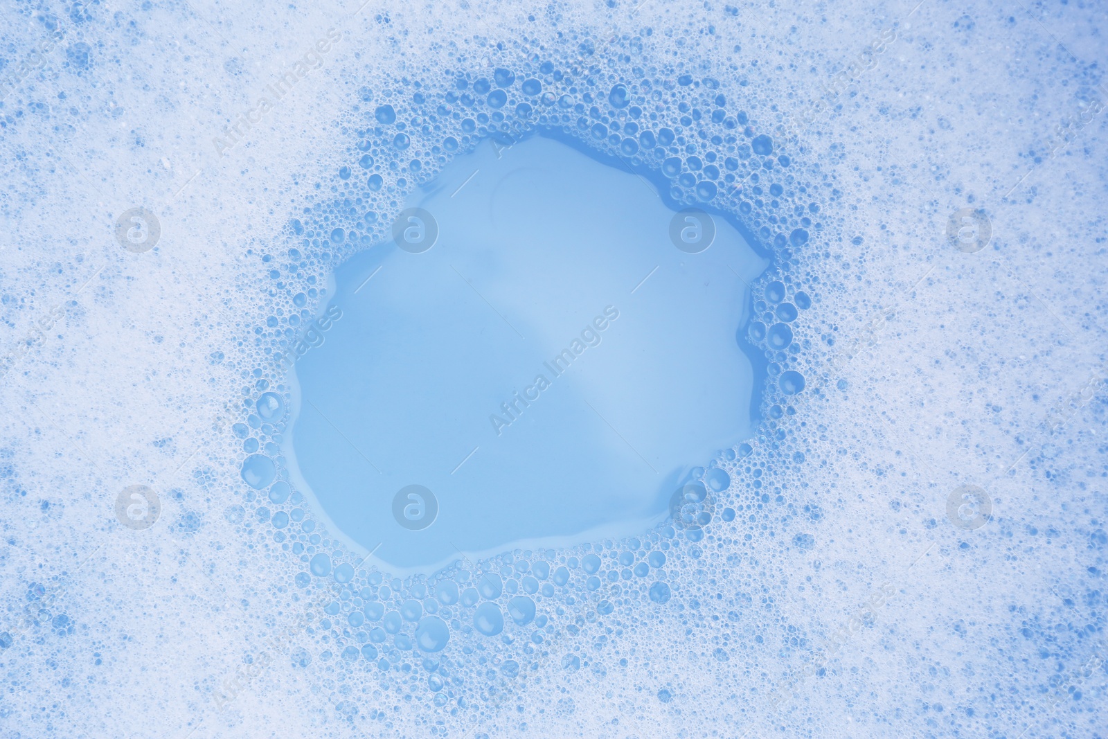 Photo of Water impregnated with soap, top view. Hand washing laundry