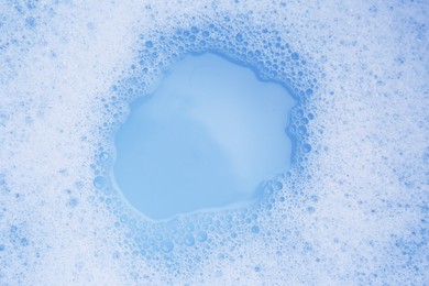 Water impregnated with soap, top view. Hand washing laundry