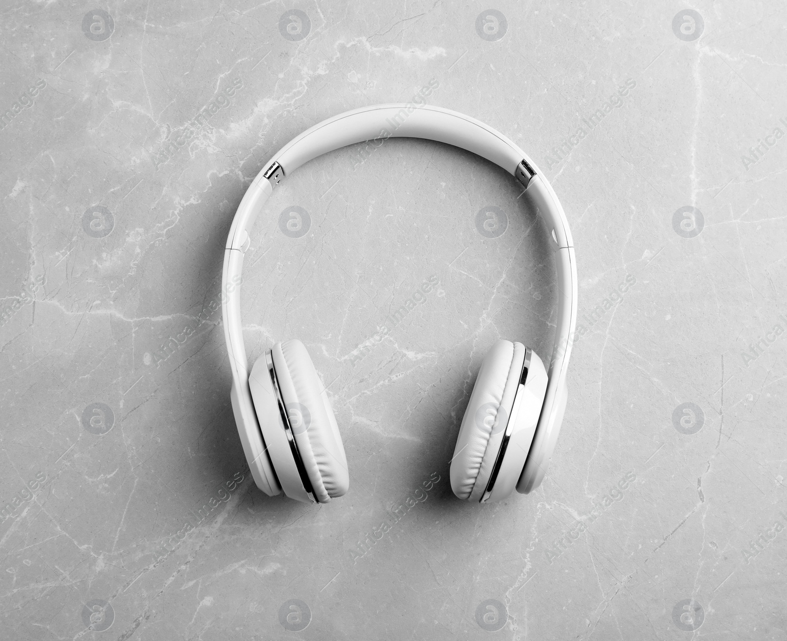 Photo of Stylish modern headphones on gray background, top view