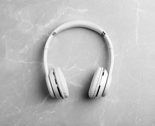 Stylish modern headphones on gray background, top view