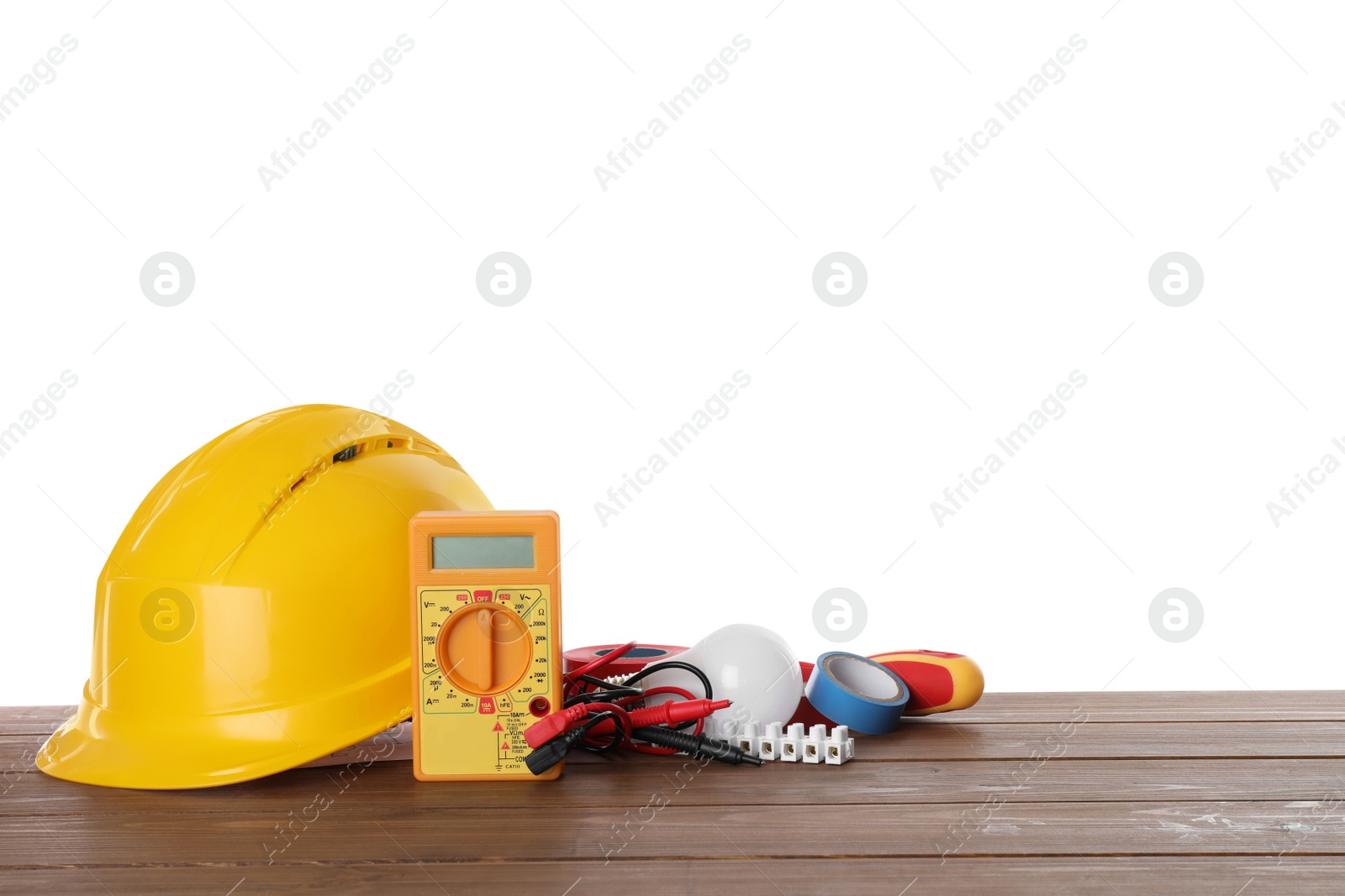 Photo of Set of electrician's tools and accessories on wooden table against white background. Space for text