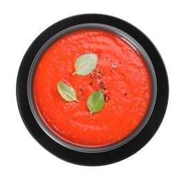 Bowl of delicious tomato cream soup isolated on white, top view